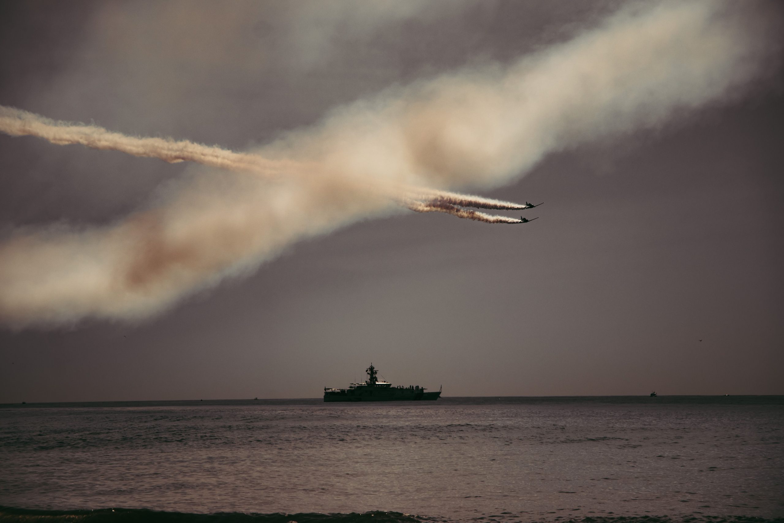 Spectacular airshow in New York Harbor with fighter jets and a ship.
